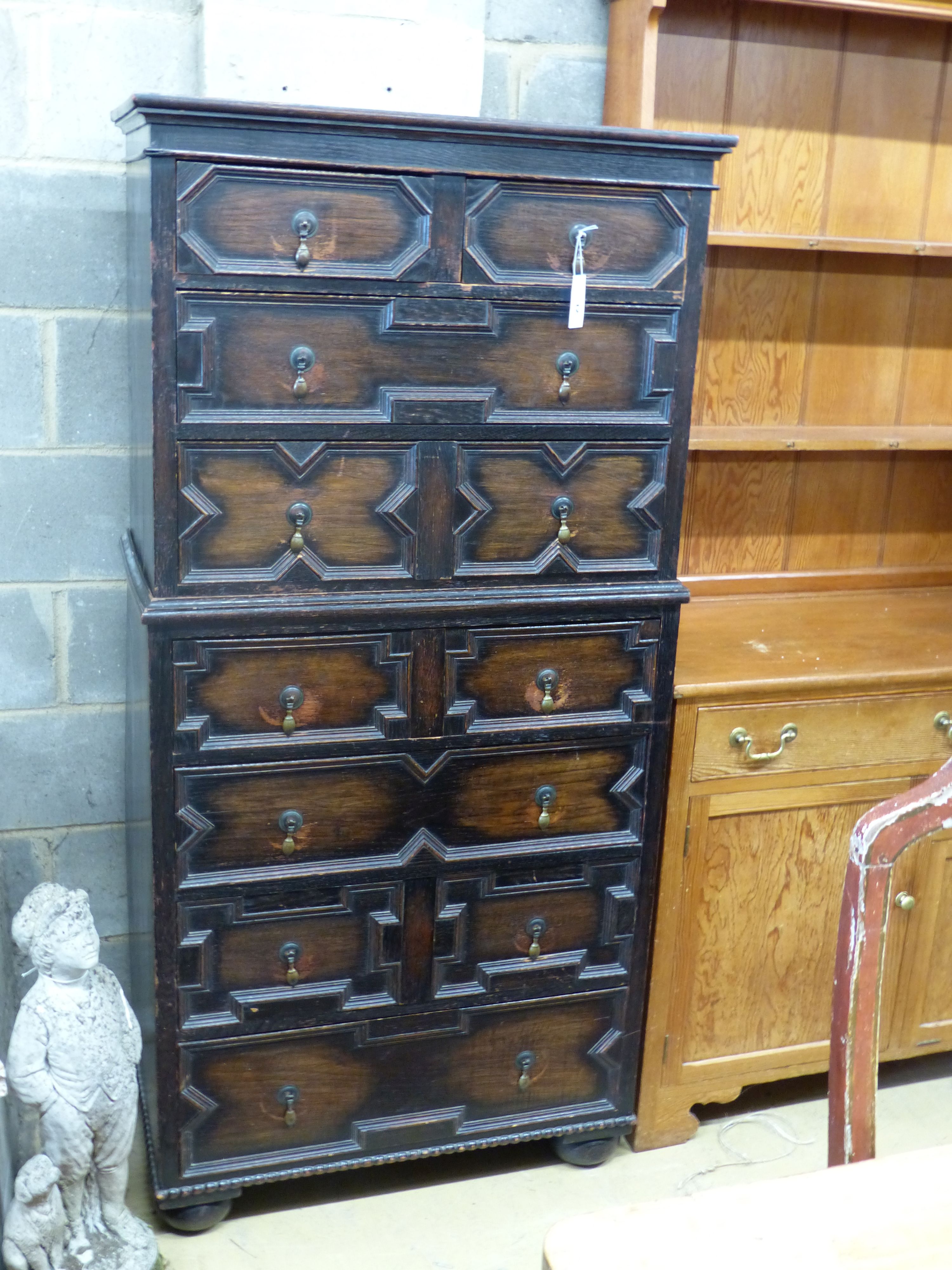 A 1920's narrow oak chest on chest, width 82cm depth 45cm height 167cm